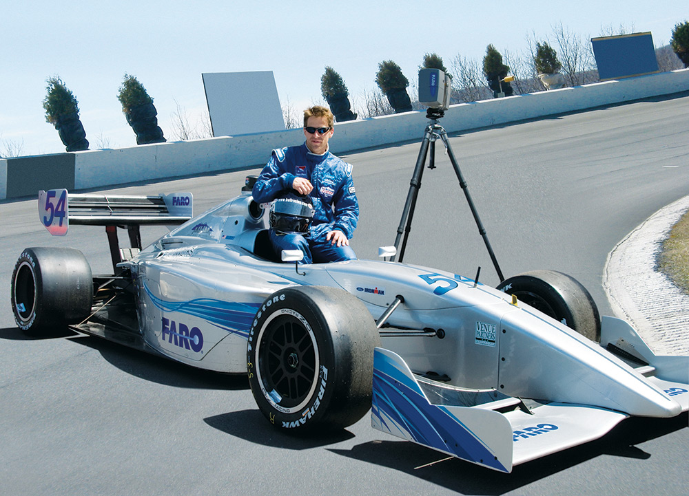 Gilbert posing with race car