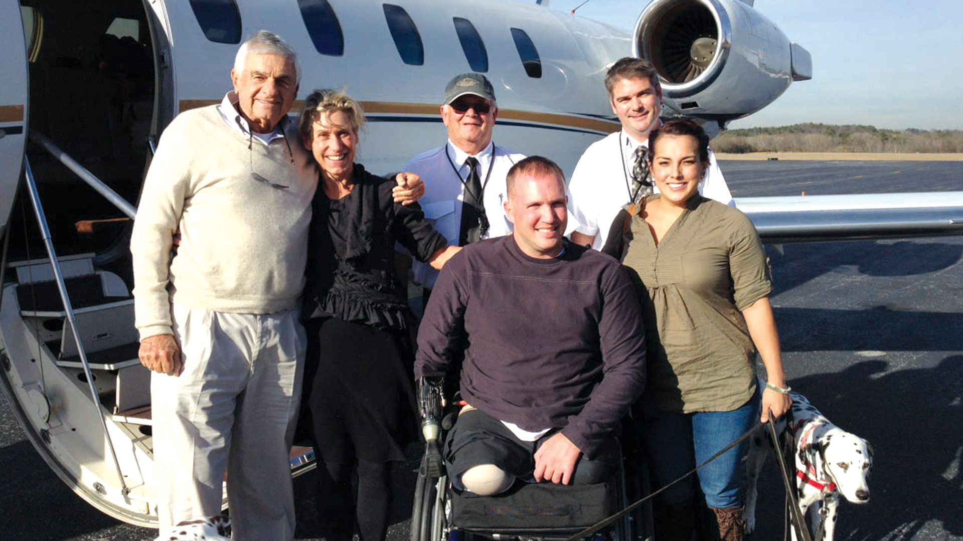 Veterans Airlift Command posing in front of aircraft