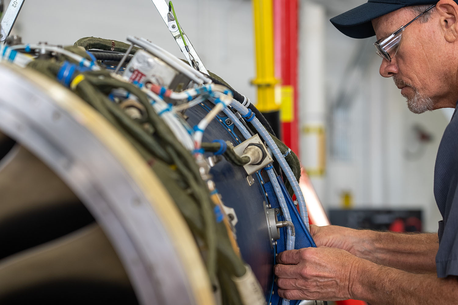 Paint technician working on aircraft wing.