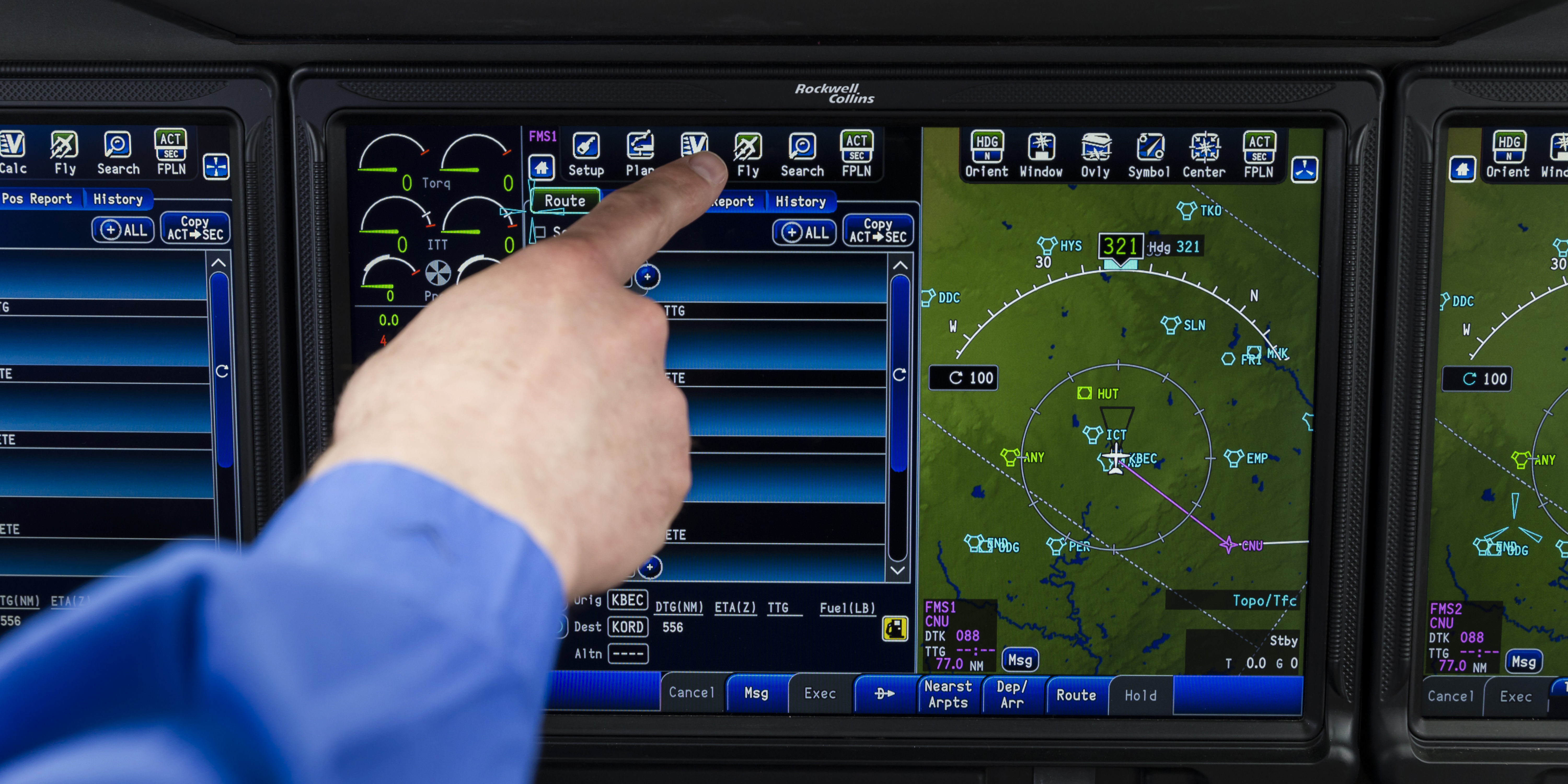 Hand pointing at a touchscreen avionics display showing flight controls and a navigation map.