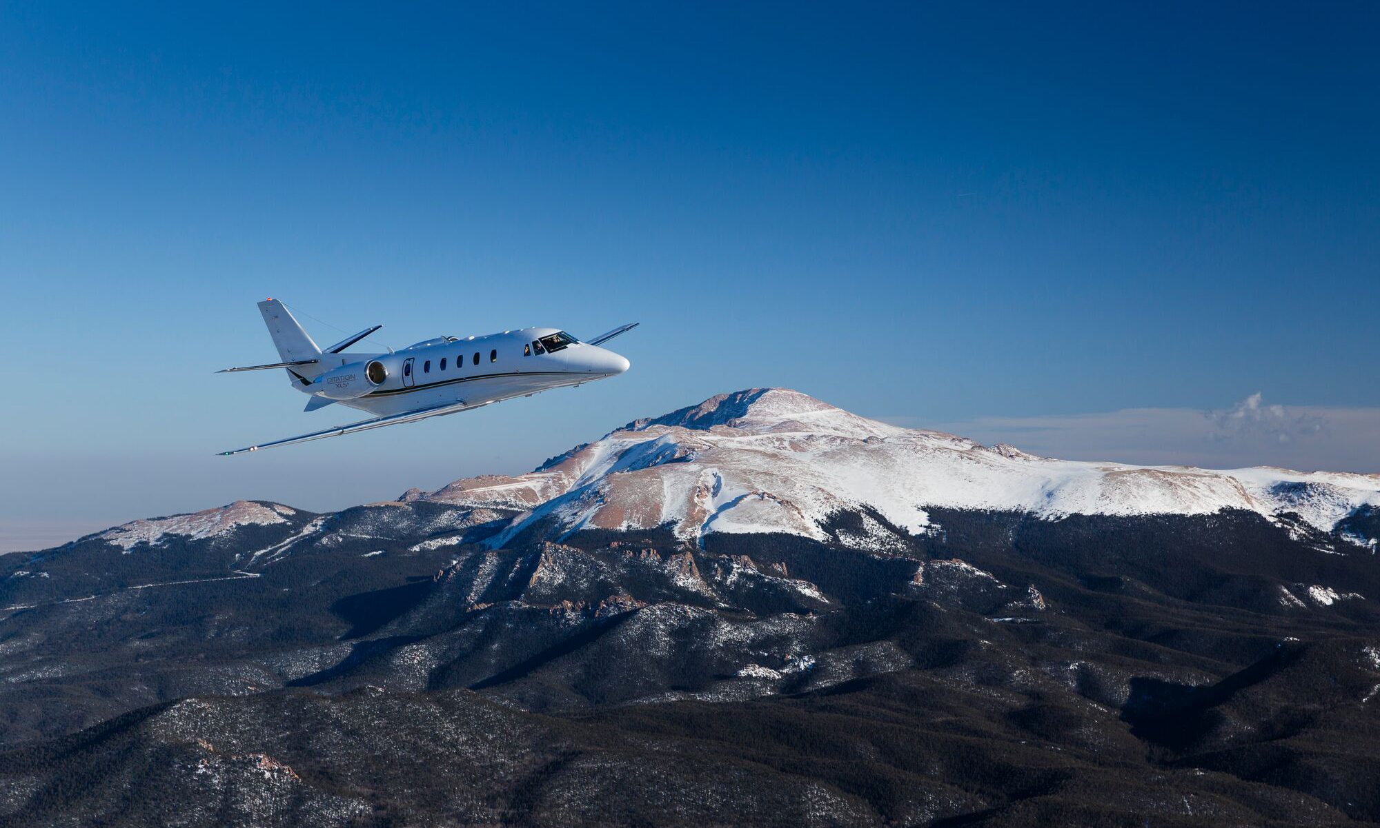 Plane flying over snowy mountain
