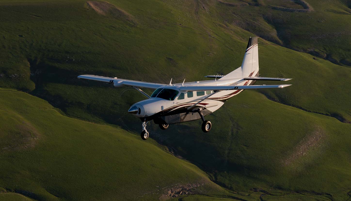 An airborne Cessna Caravan conducting an aerial survey mission