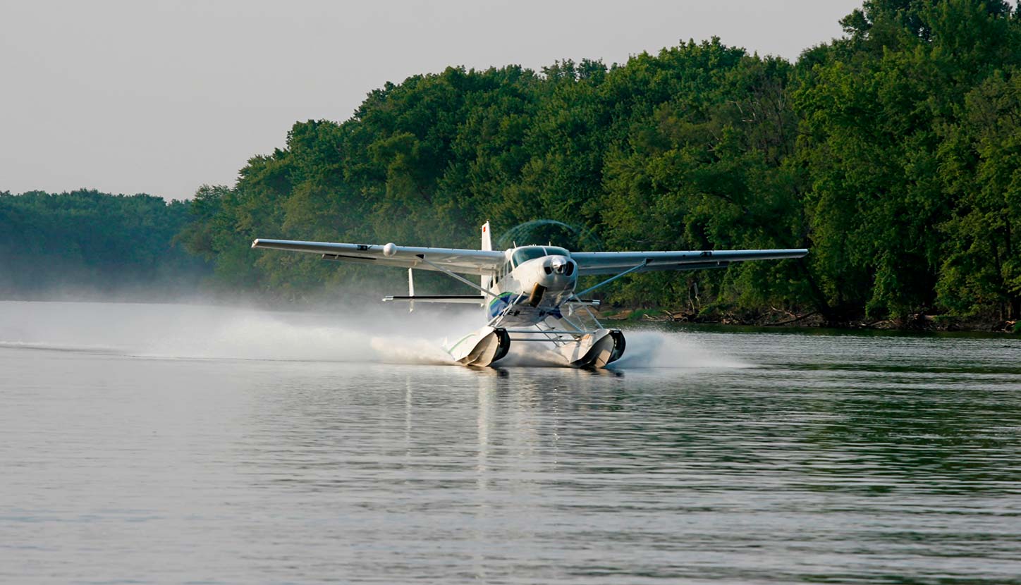 A Cessna Caravan lands on the water during an amphibian mission